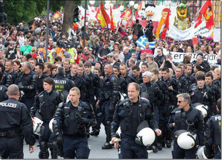 1. Frankfurt, Germany, 2011 - German riot officers take off their helmets and escort Occupy protesters
