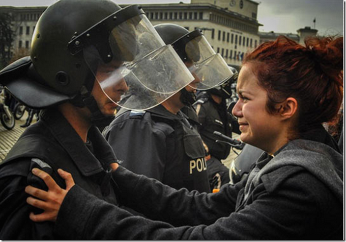 14. Sofia, Bulgaria, 2013 - Riot police and protesters share a cry together