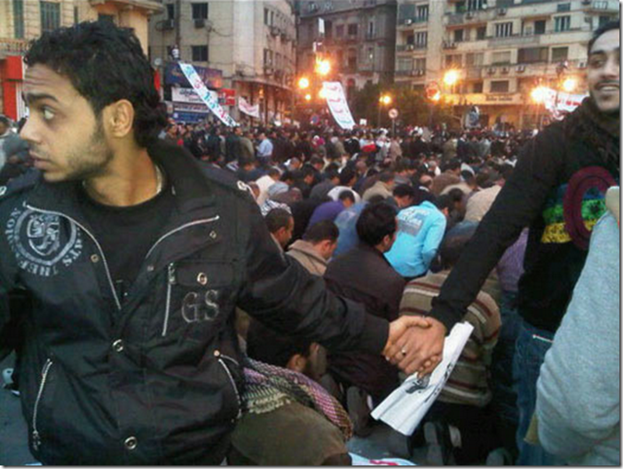 15. Cairo, Egypt, 2011 - Christians protecting Muslims as they pray during the revolution