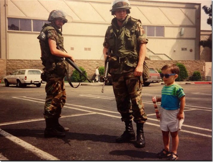 2. Los Andeles, USA, 1992 - A child poses beside National Guard members during The LA Riots