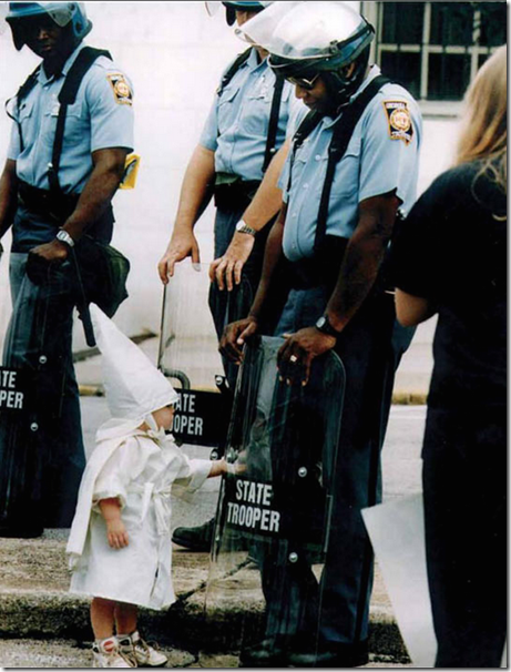 3. Georgia, USA, 1992 - Child touches his reflection during a KKK demonstration