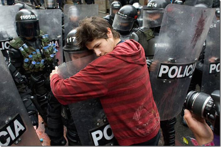 5. Bogota, Colombia, 2011 - A student protesting education reform hugs a policeman