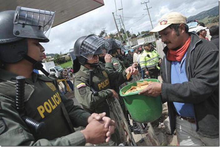 6. Columbia, 2013 - Protestors share crackers with colombian riot police