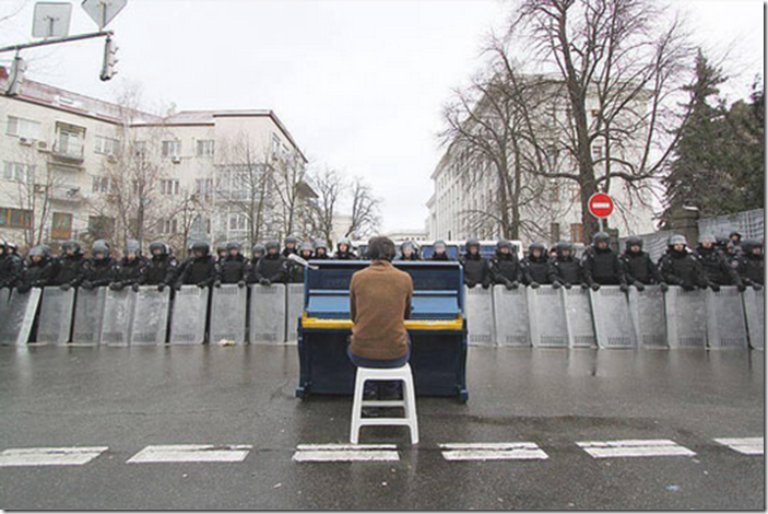 7. Kiev, Ukraine, 2013 - Man playing piano for police