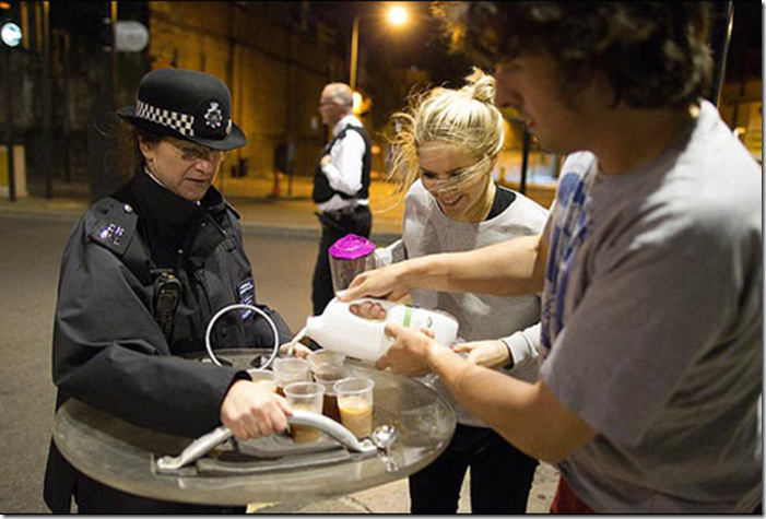 9. London, England, 2011 - Caring citizens offer tea to British riot police